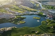 Aerial view of The Golf Club at Terra Lago South Course featuring a lake, island green par 3, and surrounding golf holes and landscape.