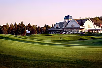 Beautiful view of Angus Glen Golf Club in Markham with a large white clubhouse, lush green fairways, and trees in the background.