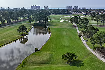 Aerial view of Azalea Sands Golf Club with lush green fairways, trees, water hazards, and no adjoining homes, designed by Gene Hamm.