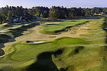 Aerial view of Long Bay Club golf course with lush green fairways, sand bunkers, and surrounding trees, designed by Jack Nicklaus.