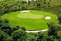 Aerial view of Punta Blanca Golf Course, an inland Caribbean golf course designed by Nick Price, featuring lush green fairways and sand bunkers.