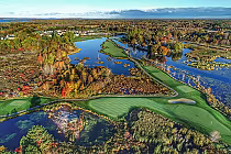Aerial view of Oak Bay Golf Club with lush green fairways, water hazards, and surrounding autumn foliage near Barrie.