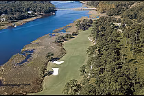 Aerial view of The Pearl golf course along the Calabash River, featuring lush green fairways, sand bunkers, and surrounding wooded areas.