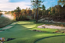 Scenic view of Muskoka Bay golf course with dramatic elevation changes, lush green fairways, and surrounding autumn trees.