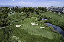 Aerial view of Green Valley Ranch golf course with lush greens, sand bunkers, water hazards, and surrounding residential neighborhood.