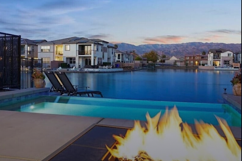 Serenity Shores, Indio CA Luxury lakefront home in Indio, CA with infinity pool, fire pit, modern architecture, mountain views, near golf courses.