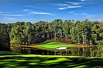 Beautiful golf course at Pursell Farms with lush green fairways, a sand trap, surrounded by trees and a reflective water hazard.