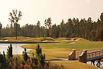 Scenic view of St. Johns Golf & Country Club in Florida with lush green fairways, water hazards, and a bridge over a pond.
