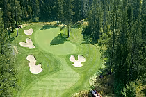 Aerial view of Tahoe Donner Golf Course with lush green fairways, sand bunkers, and surrounding trees in a scenic forest setting.