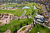 Aerial view of Wildhorse Golf Club in Henderson, Nevada, showcasing lush greens, water features, and surrounding pathways.