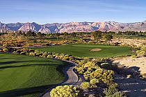 Scenic view of Angel Park Golf Club's Cloud Nine hole with lush green fairways, sand trap, and mountain backdrop.
