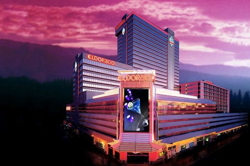 Luxurious El Dorado casino hotel in Reno illuminated with pink and purple sunset sky, featuring neon signs and digital displays.