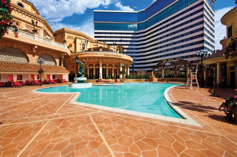 Luxury pool area at Peppermill Resort Spa Casino in Reno, featuring a large swimming pool, elegant architecture, and modern high-rise buildings.
