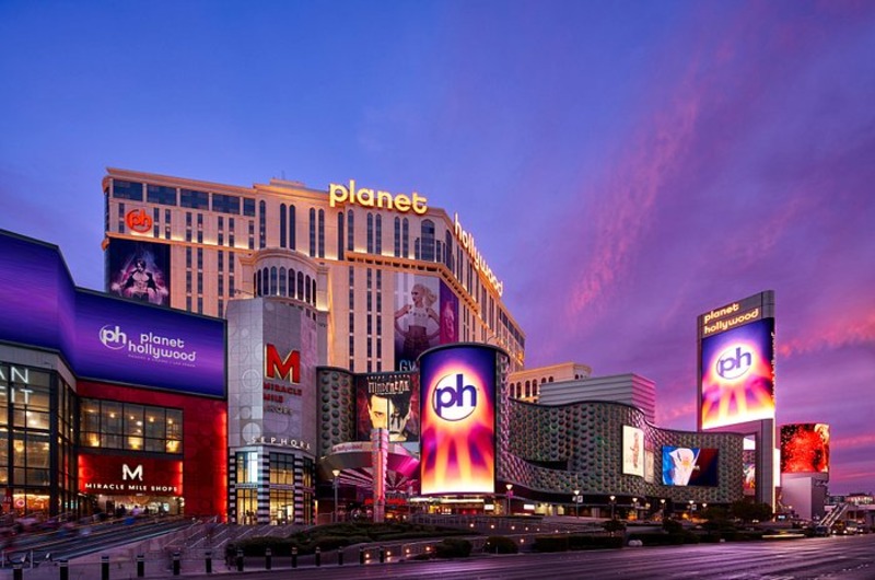 Planet Hollywood Resort & Casino Night view of Planet Hollywood Resort & Casino in Las Vegas with bright digital billboards and colorful sky.