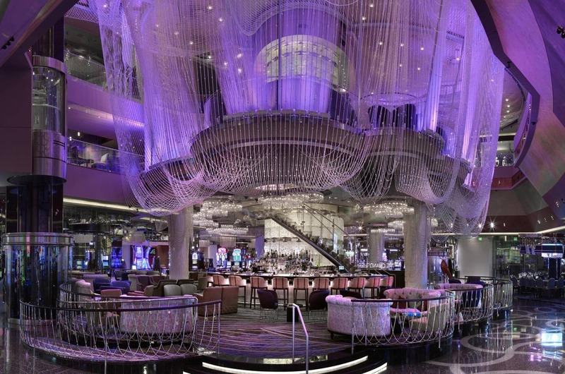 The Cosmopolitan of Las Vegas Luxurious lobby of The Cosmopolitan of Las Vegas with elegant purple lighting, modern seating, and a grand chandelier.