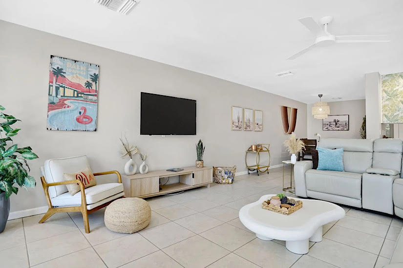 The Springs: Palm Springs, CA Bright, modern living room with white furniture, artwork, and decor, in a luxurious Palm Springs hotel or resort setting.