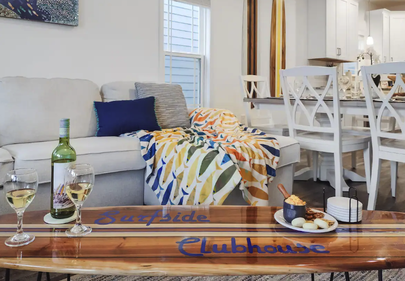 Surfside Clubhouse Interior of Surfside Clubhouse with a cozy sofa, colorful blanket, dining table, and high-end amenities for a luxury golf vacation.