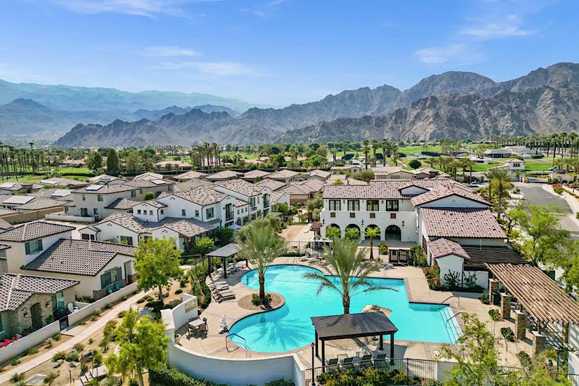 PGA West: La Quinta, CA Luxury golf resort in La Quinta, California with a swimming pool, surrounded by residential homes and mountain views.
