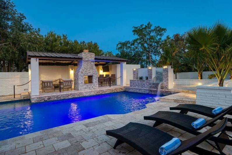 Luxurious Scottsdale desert retreat with a private pool, lounge chairs, and outdoor seating area, perfect for family golf vacations.