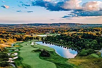 Aerial view of The Paintbrush golf course in Caledon, featuring lush green fairways, sand traps, water hazards, and surrounding trees.