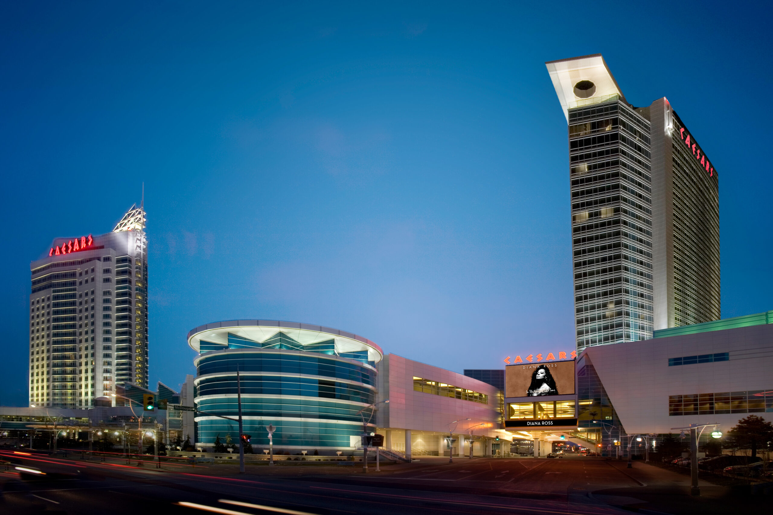 Caesars Windsor Night view of Caesars Windsor hotel and casino with illuminated signs, modern architecture, and a clear evening sky.