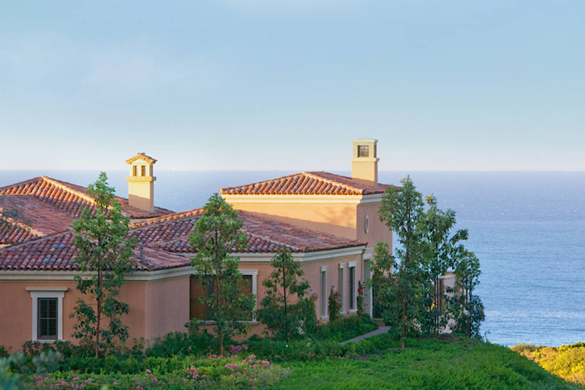 Luxury bungalow with Tuscan-style interiors and private terraces at The Resort At Pelican Hill, overlooking the ocean.